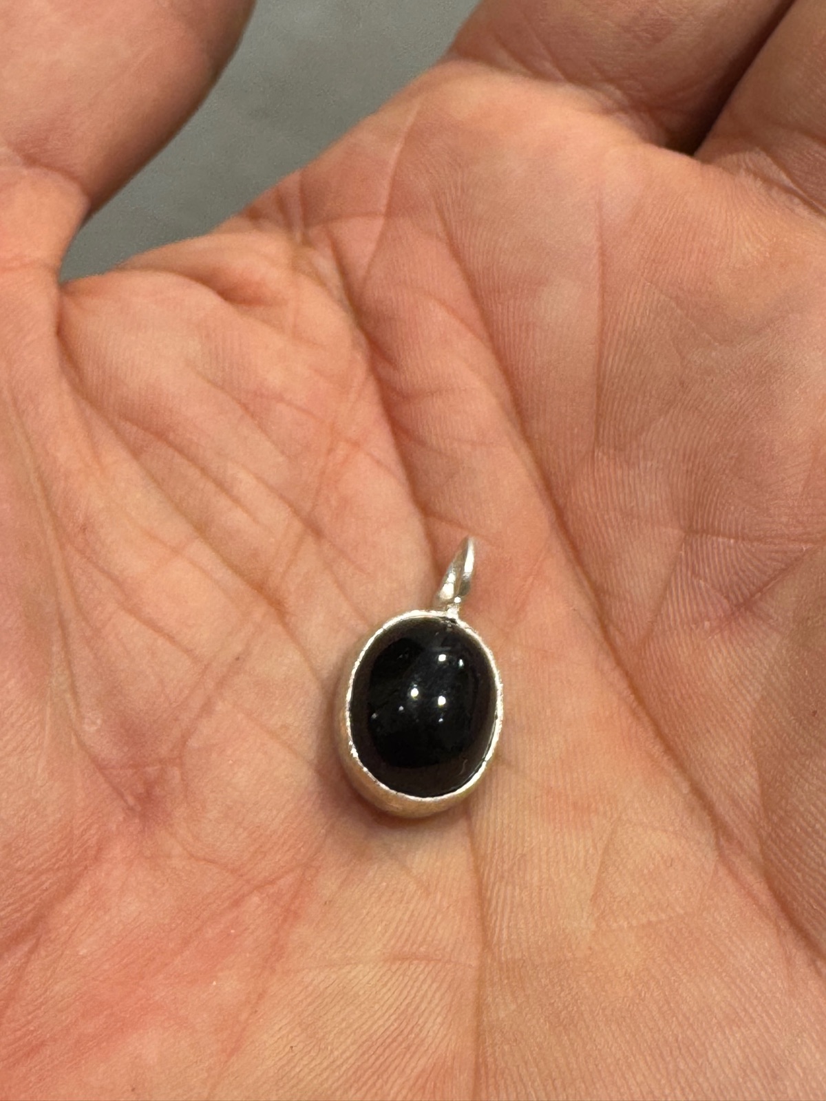 Black onyx cabochon pendant set in silver